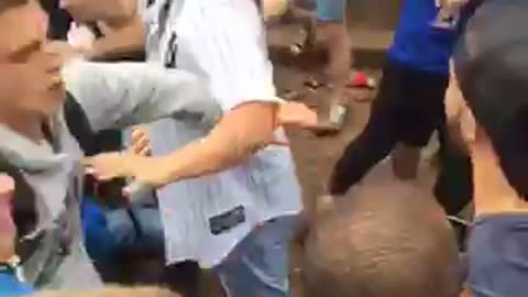 Guy green jersey punches guy in blue shirt