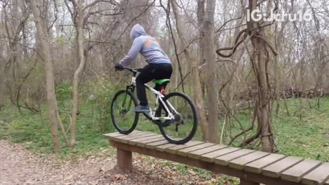 White and green mountain bike off wood walk way front tire fail