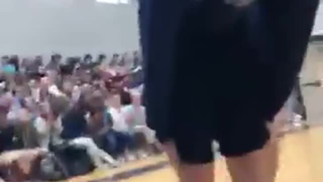 Guy in purple tries to do dance move and falls down.