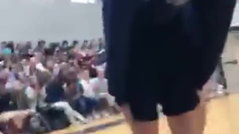 Guy in purple tries to do dance move and falls down.