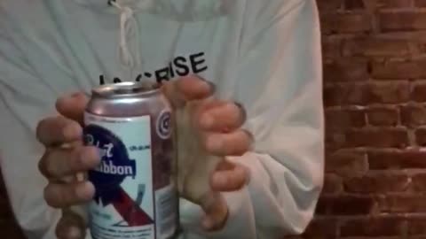 Guy in white la crise sweater does floating tricks with white beer can