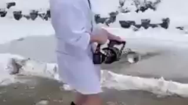 Guy cleaning snow from driveway