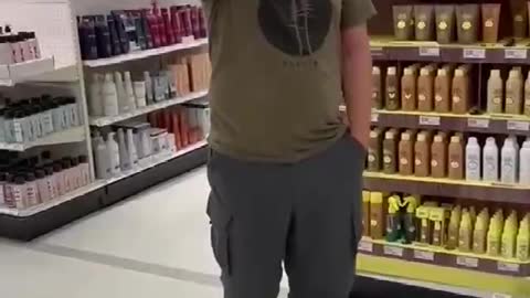 This weirdo following a woman around a store pointing at her for not wearing a face mask!