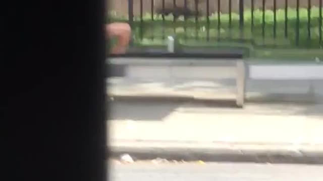 Man in blue shorts push ups at bus stop