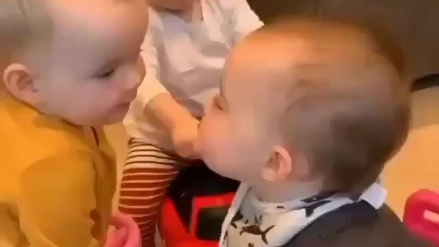 Baby One-year-old girl excitedly meets her newborn baby brother