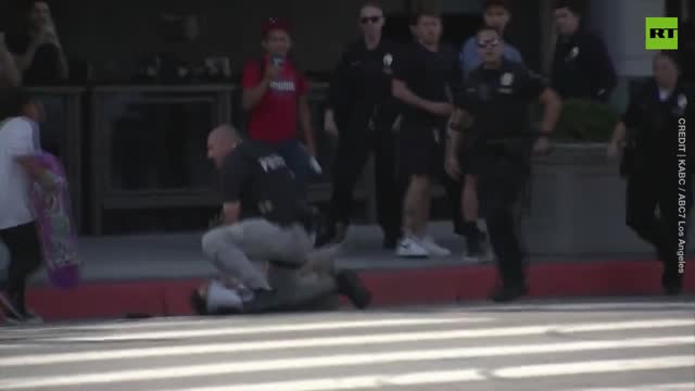 Tuff Guy Cop Treatened by Lady with a bullhorn as motorcade passes by