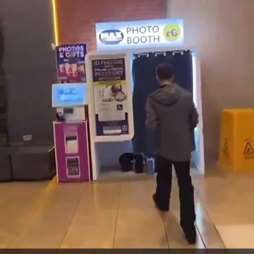 Woman gets caught performing a sexual act on a man in a Photo Booth