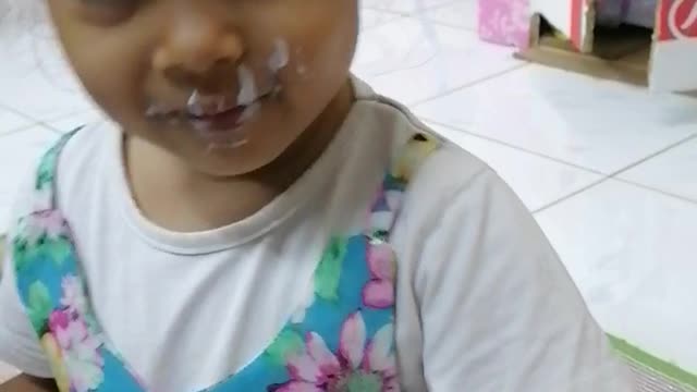 funnny Beby loves eating yogurt