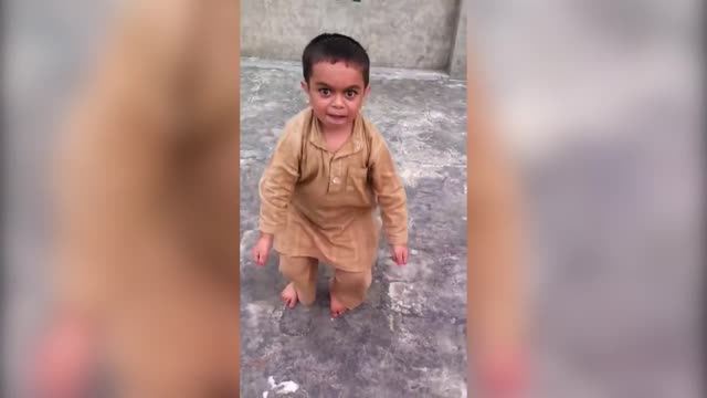 Kid dancing when other kid is singing