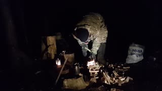 Making and lighting a campfire under a tarp. Woodland wildcamping