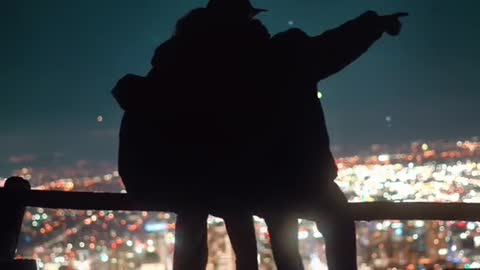 The couple sat on the railing at the top of the hill