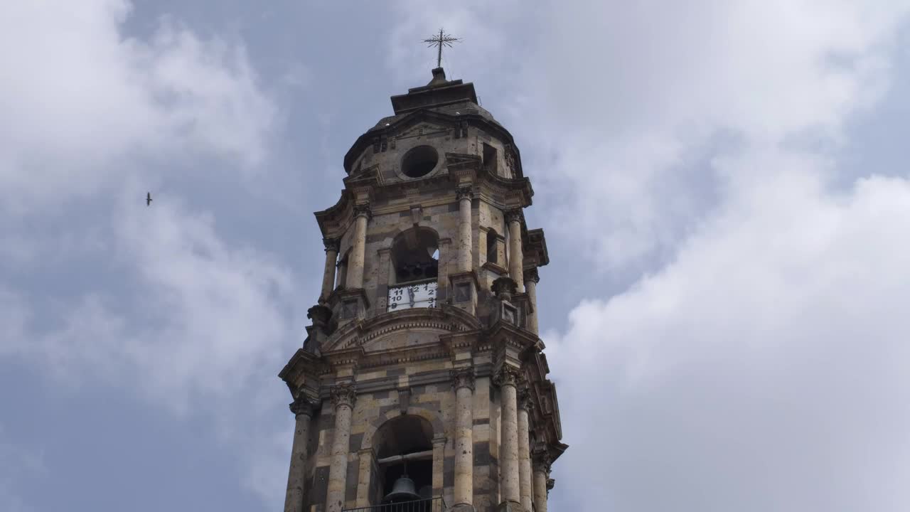 Tower of a church with a clock on a sunny day