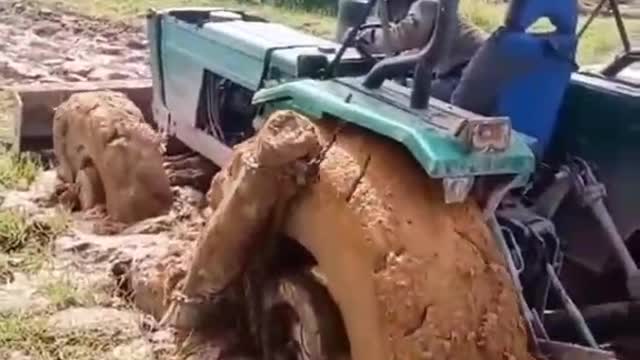 A tractor stuck in the mud. How do you get out