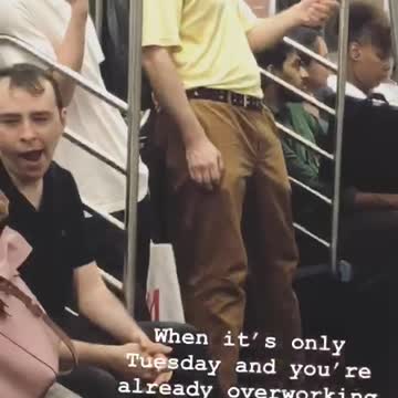 Man in yellow shirt fiddling with stress ball