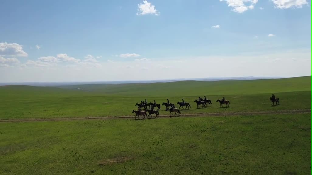 A group of people riding on grassland