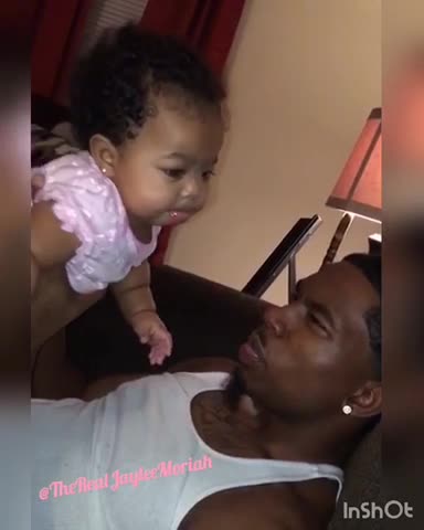 Cute baby girl loves blowing spit bubbles with Dad