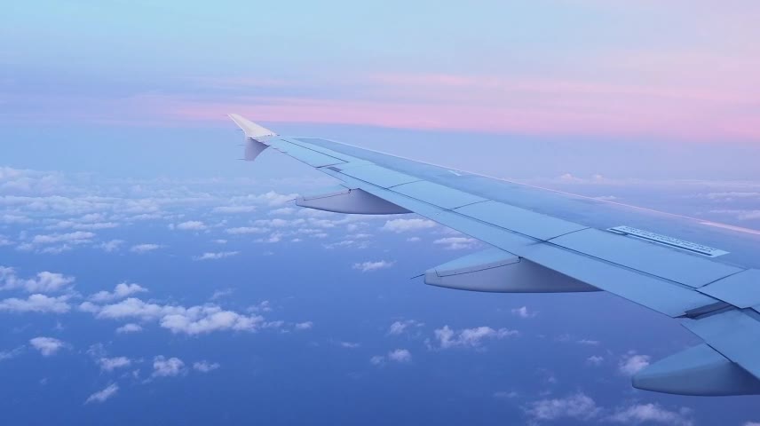 Pink sunset seen from a plane window