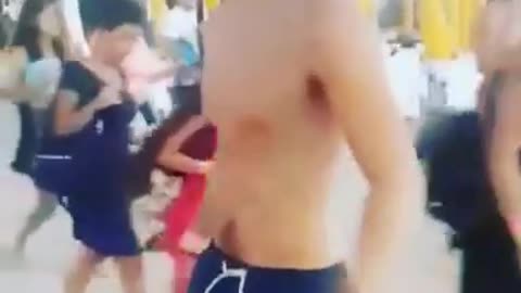 Man in blue swim trucks tries to do backflip on sand but underrotates and lands on head