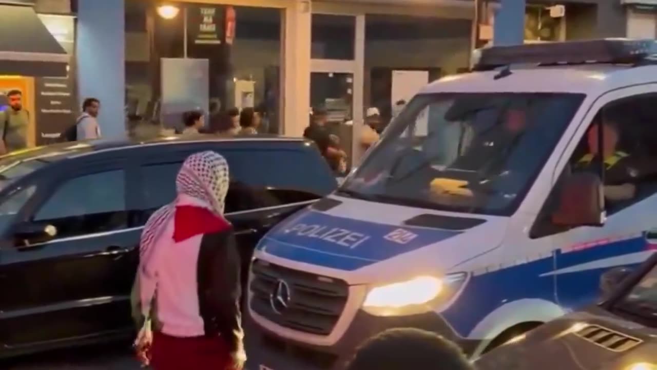 Muslim taunts police officer and tries to open his car door in Germany - cop does nothing