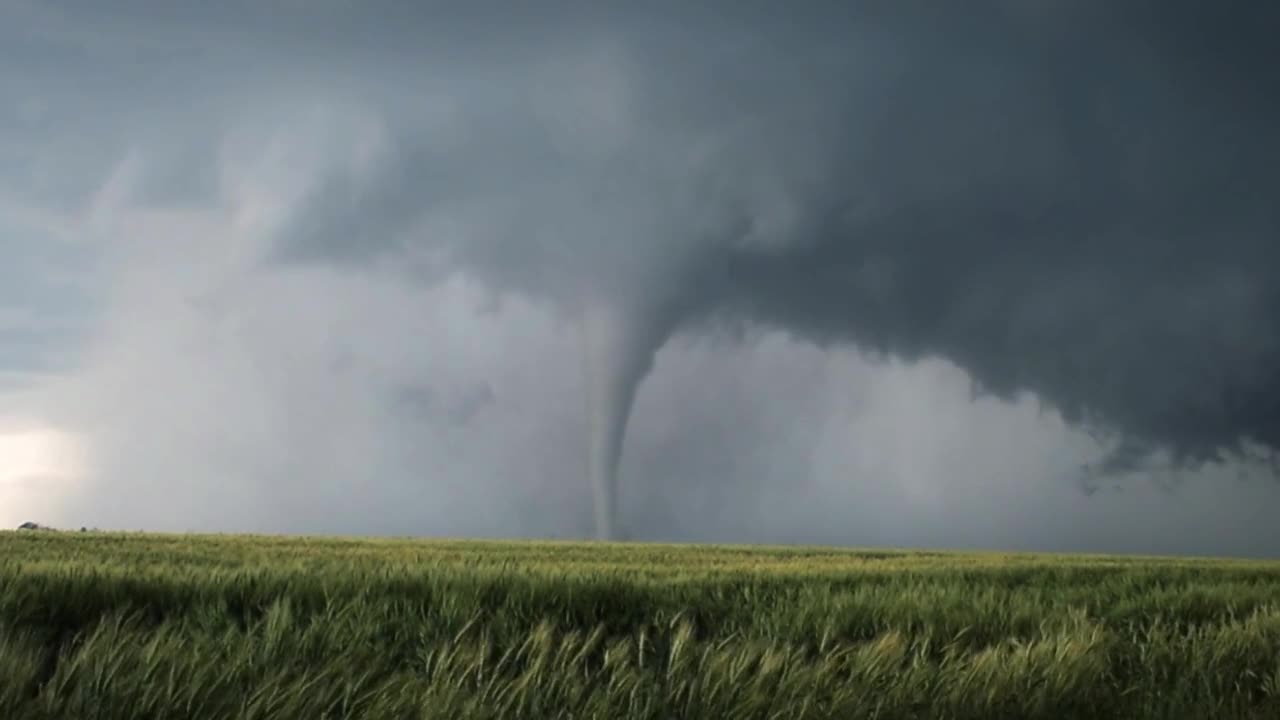 A huge tornado sweeps across the field