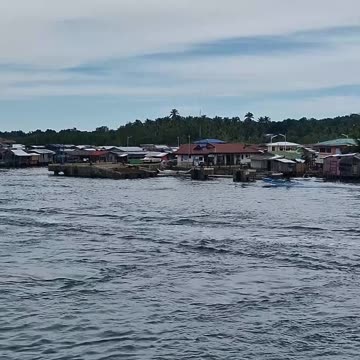The Sea Gypsies of the Philippines, Arriving at Isabela, Basilan see many houses of the Badjao