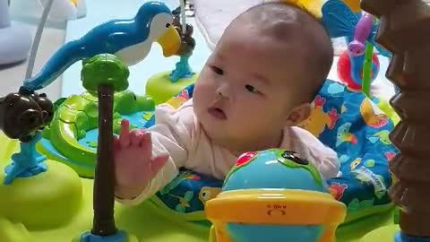 My 4 month old baby playing at Exer Saucer for the first time sitting