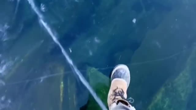 Crystal clear ice and sound stones at the bottom