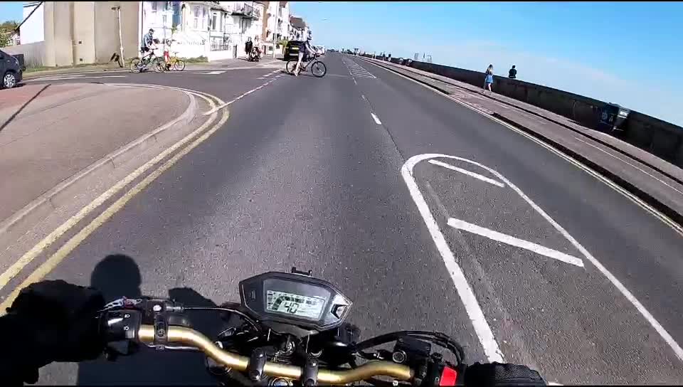 Cyclist Cuts into Road in Front of Motorcycle