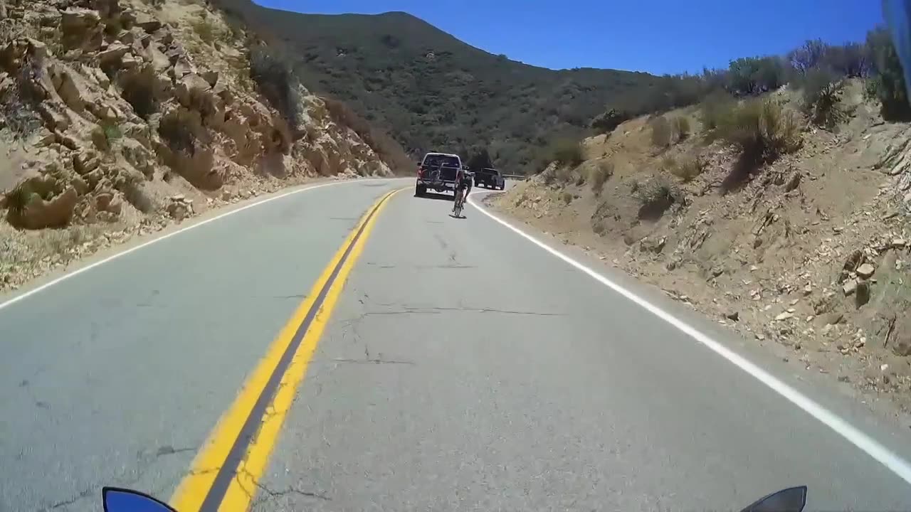 Cyclist joins, then overtakes motorcycles