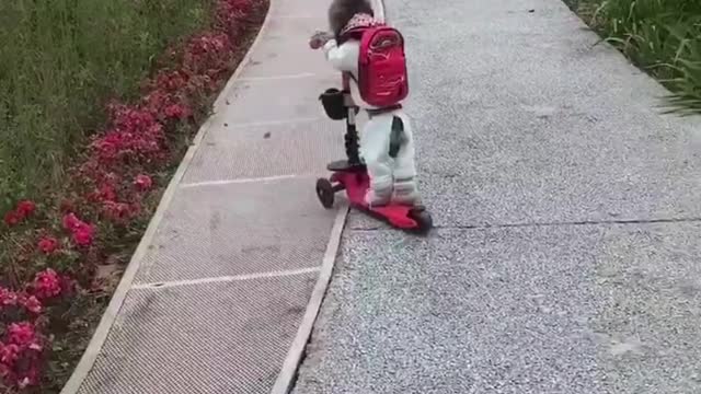 Teddy loves riding his scooter