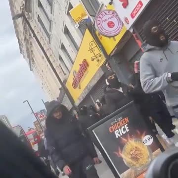 Armed immigrants running through the streets.