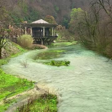 A fast river among green banks