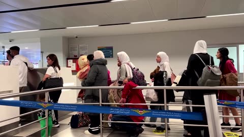 Passengers line up at Beirut's airport after Israeli airstrikes