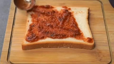 Spread The Slices Of Bread With Pizza Sauce