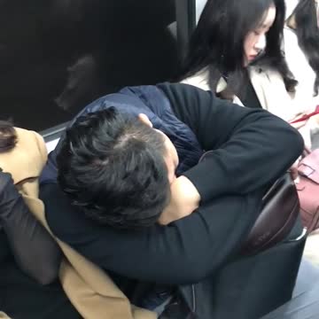 Man asleep on woman in brown trench coat