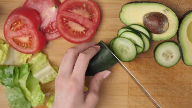 Top view of a woman slicing vegetables