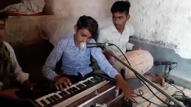 Indian boy playing harmonium