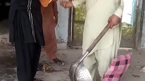 Man playing cricket using dasi (local) safety kits