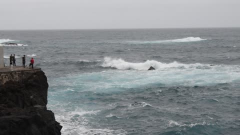 Water waves crashing into rocks