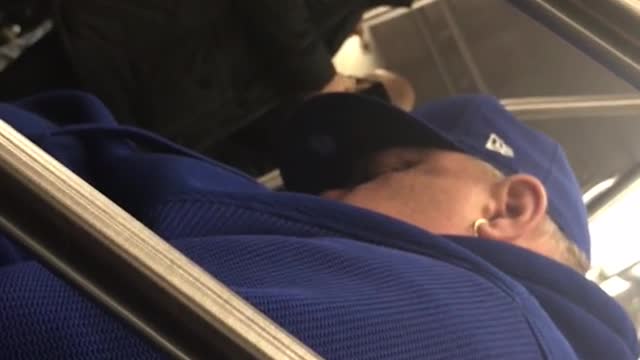 Man sleeps on subway train and hits his head on handrail