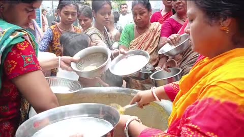 Serving fresh kitchari (rice, lentils) on Oct 8 in Bangladesh