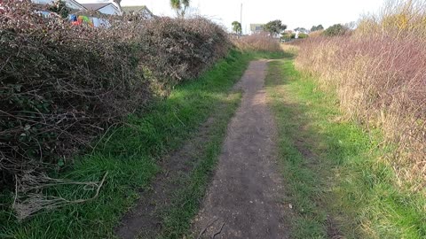 Beginning of the path next to a river. Near the
