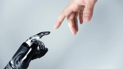 A Human Hand Touching Prosthetic Arm