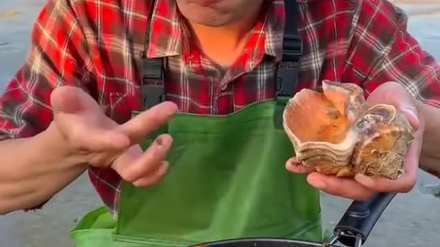 Young man cooking and eating seafood look like so delicious