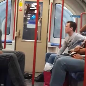 Man dancing sticking hands through subway door