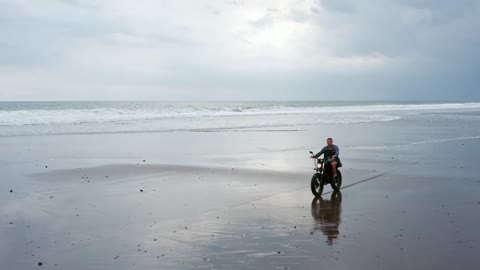 Man riding a motorcycle on the beach
