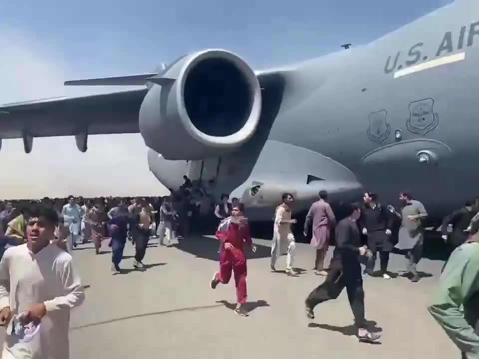 People attempting to flee Kabul on US Air Force plane