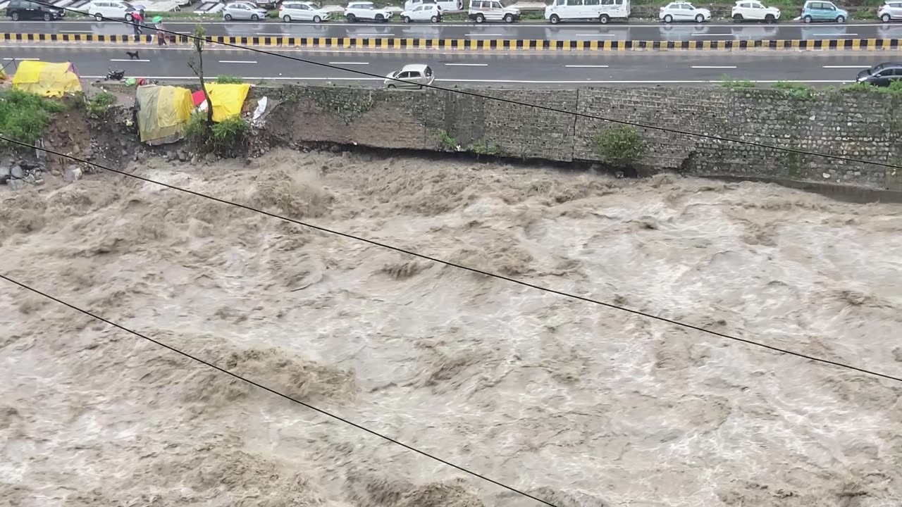 Car Swept Into River by Heavy Rainfall