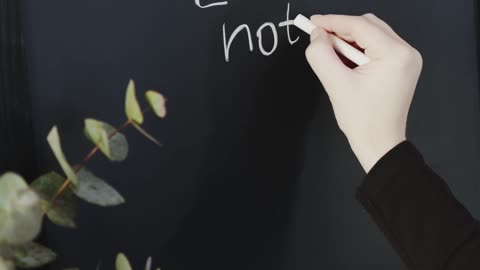 Writing A Message In A Blackboard Using A Chalk