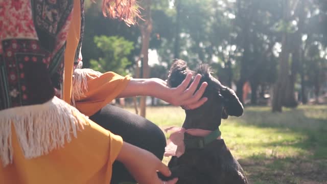 A Woman Petting Her Dog